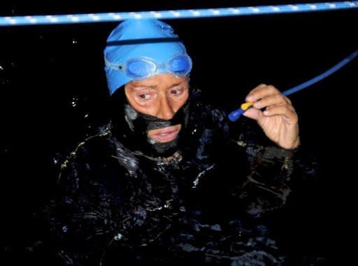 Diana Nyad takes a break after reportedly being stung by a jellyfish on August 18 off Havana, Cuba. The swimmer comes up to her Voyager escort boat, which she is not allowed to touch, around every 90 minutes to fuel up, sipping on a concoction of nutrients, electrolytes and calories through a Camelbak hydration pack