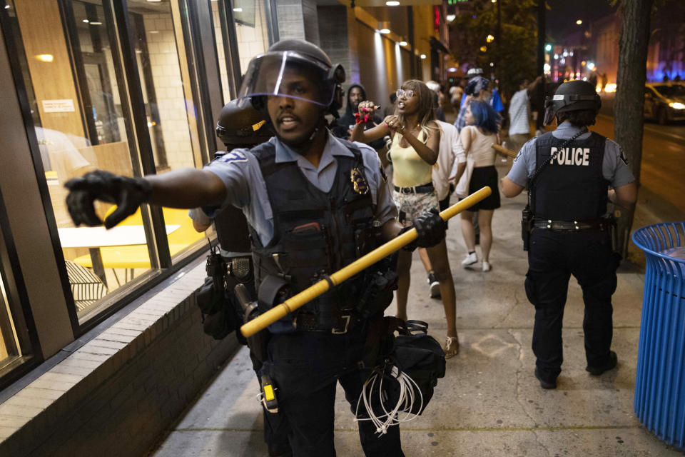 Protesters clash with police after a vigil was held for Winston Boogie Smith Jr. early on Saturday, June 5, 2021. Authorities said Friday that a man wanted on a weapons violation fired a gun before deputies fatally shot him in Minneapolis, a city on edge since George Floyd's death more than a year ago under an officer's knee and the more recent fatal police shooting of Daunte Wright in a nearby suburb. (AP Photo/Christian Monterrosa)