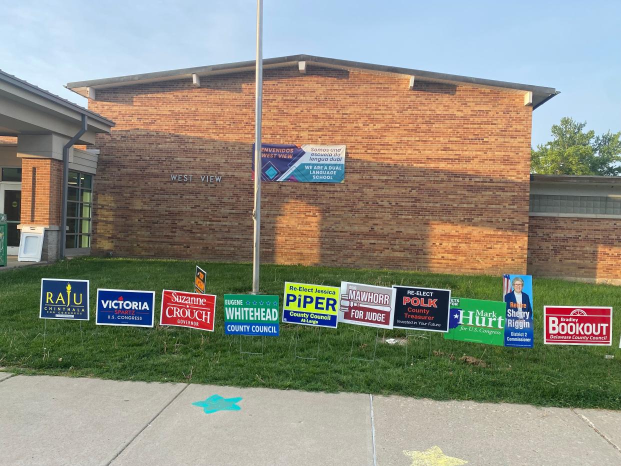Political signs are set up Tuesday at West View Elementary School, 3401 W. Gilbert St., where voters in Precinct 38 cast ballots.