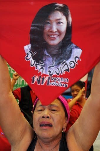 A supporter of Yingluck Shinawatra shouts slogans during a rally last year outside the Puea Thai headquarters in Bangkok. Thailand says it is boosting security ahead of an incendiary charter amendment case that could lead to the dissolution of the ruling party, with judges given special police protection