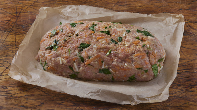 Raw meatloaf on wax paper