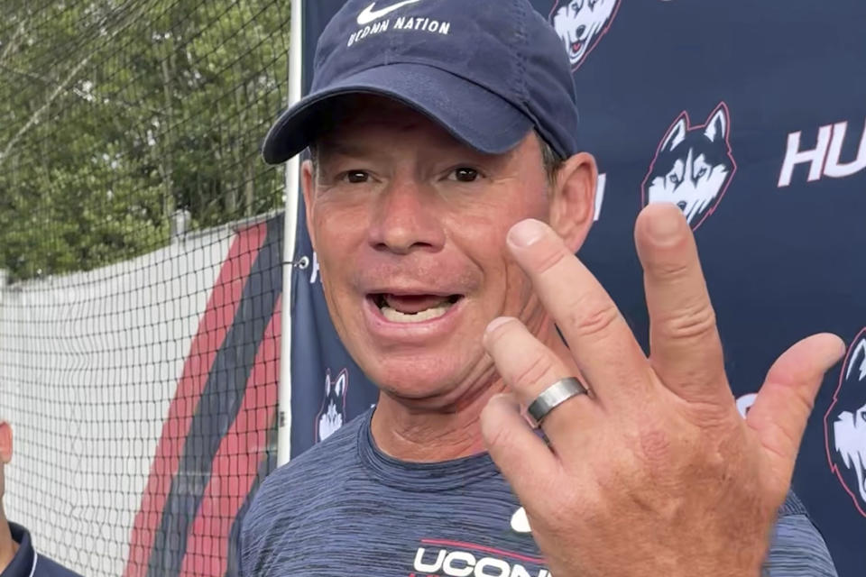 Connecticut head football coach Jim Mora speaks to reporters during the opening day of NCAA college football training camp on July 29, 2022, in Storrs, Conn. Mora is trying to rebuild the football program as an independent in an era of conference mega-mergers.(AP Photo/Pat Eaton-Robb)