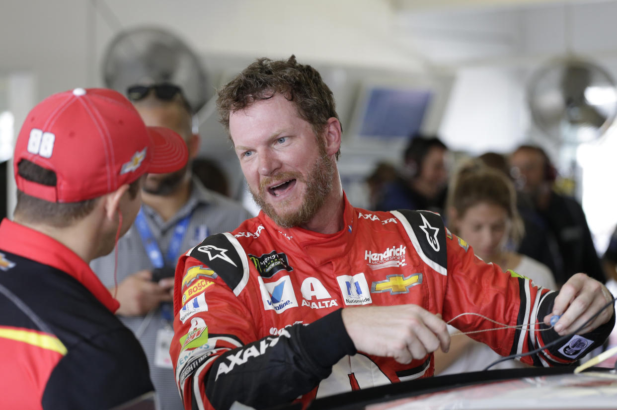 Dale Earnhardt Jr. shares a laugh with a crew member after practice for Sunday’s NASCAR Cup Series auto race at Homestead-Miami Speedway in Homestead, Fla., Saturday, Nov. 18, 2017.(AP Photo/Terry Renna)