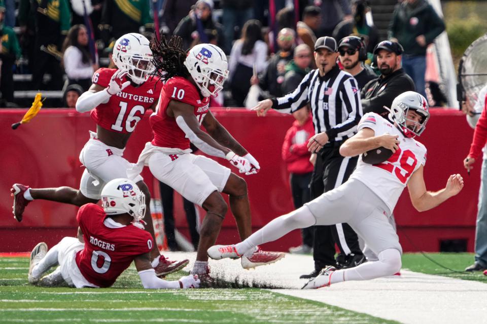 Nov 4, 2023; Piscataway, New Jersey, USA; Rutgers Scarlet Knights defensive back Flip Dixon (10) hits Ohio State Buckeyes punter Jesse Mirco (29) on an attempted fake punt during the first half of the NCAA football game at SHI Stadium.