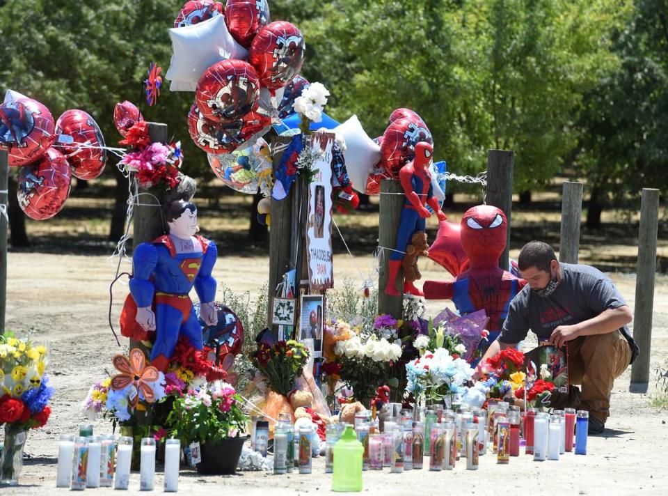 Marcos Gallegos pays his respects to 2-year-old Thaddeus Sran, Saturday July 25, 2020, at a Road 21 memorial west of Madera set up near where authorities found remains believed to be Thaddeus’ body.