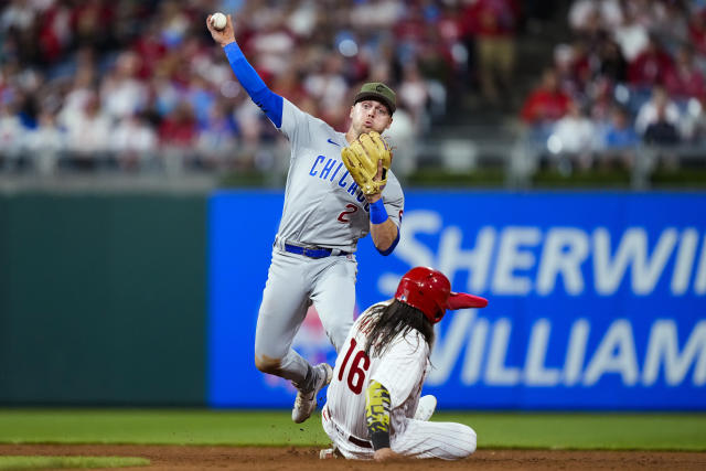 Chicago Cubs' Nico Hoerner throws to first after forcing out Philadelphia Phillies' Brandon Marsh on a double play hit into byEdmundo Sosa during the fifth inning of a baseball game Friday, May 19, 2023, in Philadelphia. (AP Photo/Matt Rourke)