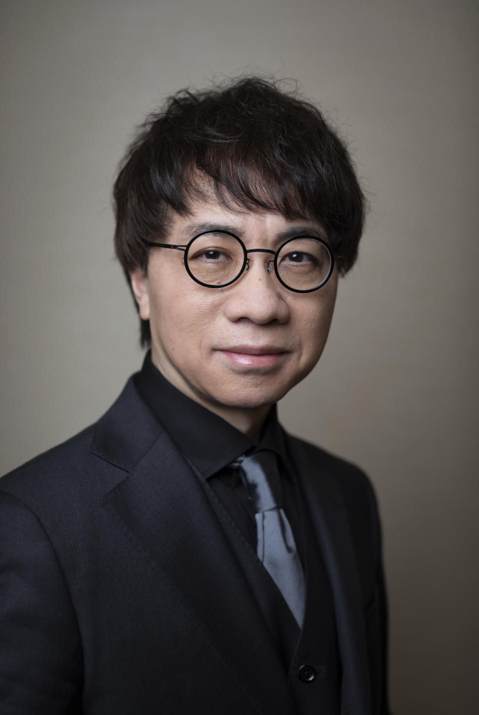 Makoto Shinkai poses for a portrait to promote the film "Suzume" on Tuesday, March 28, 2023 in New York. Shinkai was never the same filmmaker after the 2011 earthquake stuck Japan. His top three films since – "Your Name," "Weathering With You" and the new release "Suzume" -- have each tethered hugely emotional tales to ecological disaster. And they account for some of the biggest anime hits of all time. "Suzume" has already grossed more than $200 million. (Photo by Matt Licari/Invision/AP)