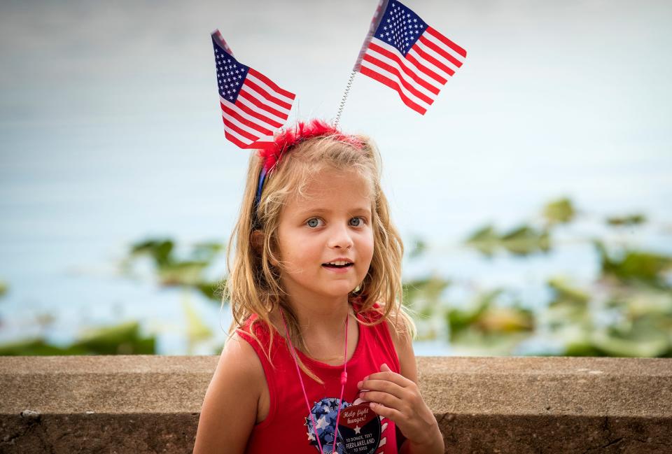 Emelia Carrozza wears a flag headband during Lakeland's Red White & Kaboom festival at Lake Mirror in 2018.