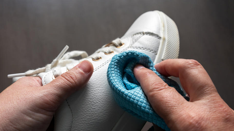 someone cleaning a shoe