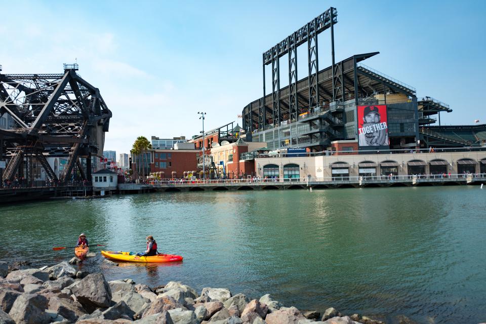 </a> Two kaykers paddle through McCovey Cove near ATT Park, the baseball stadium of the San Francisco Giants, in the China Basin neighborhood of San Francisco, California, August 21, 2016. Boats often gather in the cove during home games in hopes of catching homerun balls which have been hit out of the ballpark and into the waters of the cove, San Francisco, California. (Photo by Smith Collection/Gado/Getty Images).Smith Collection/Gado Getty Images