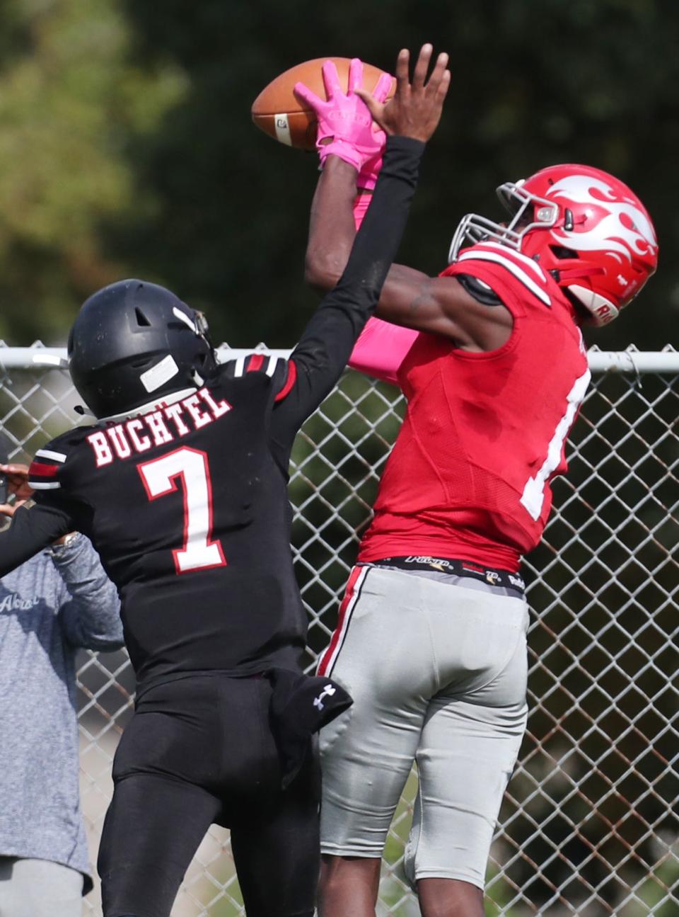 East's Eric Holley III makes a catch as Buchtel's William Ambler defends in their City Series game at Buchtel High School on Saturday, Oct, 2, 2021 in Akron.