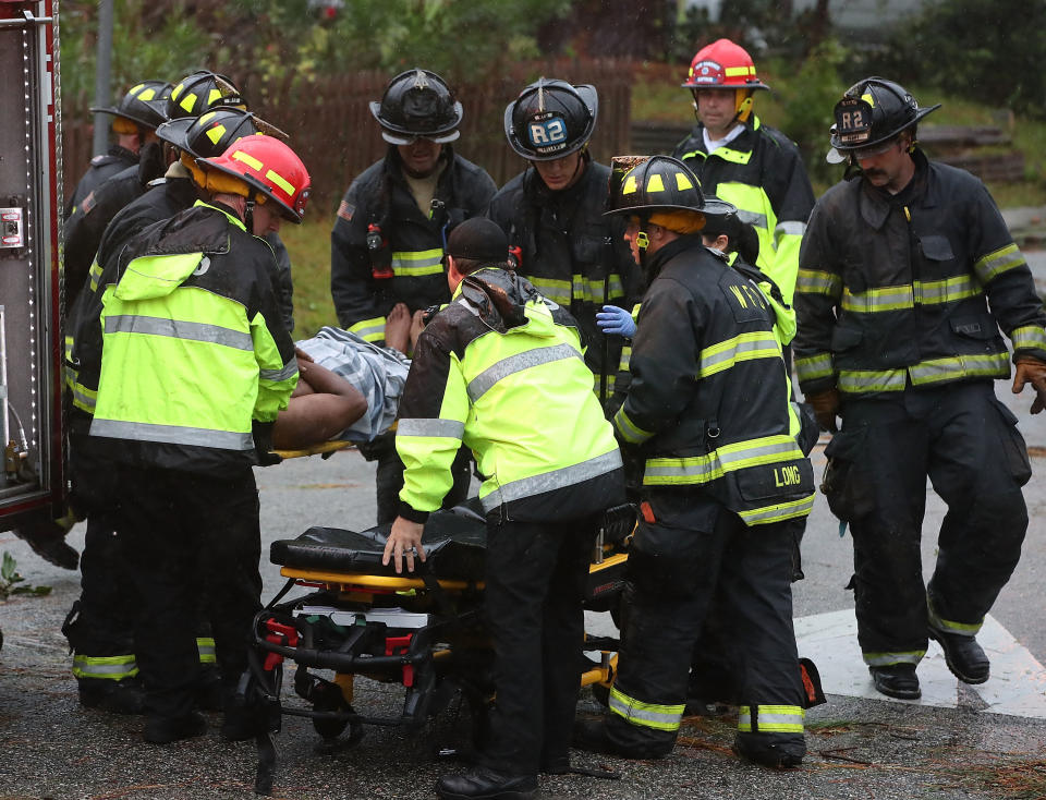 Firefighters rush the injured father to an ambulance. Source: Getty