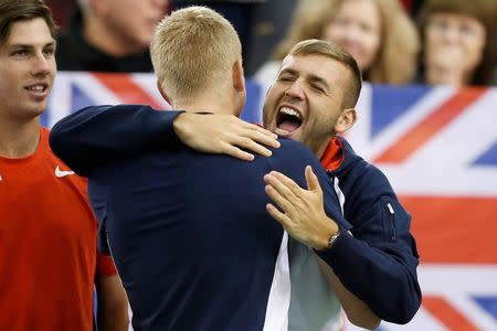 Tennis - Canada v Britain - Davis Cup World Group First Round - Ottawa, Ontario, Canada - 5/2/17. Britain's Kyle Edmund celebrates with teammate Daniel Evans (R) following his singles match against Canada's Denis Shapovalov. REUTERS/Chris Wattie