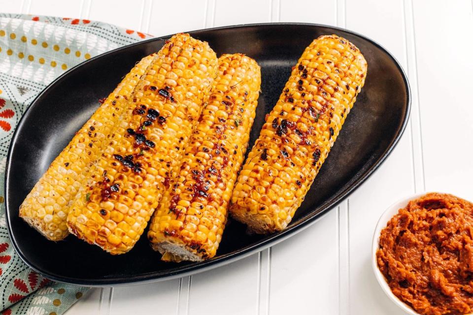 <p>This grilled corn is a great dish to serve alongside <a href="https://www.thedailymeal.com/cook/how-grill-perfect-steak-gallery?referrer=yahoo&category=beauty_food&include_utm=1&utm_medium=referral&utm_source=yahoo&utm_campaign=feed" rel="nofollow noopener" target="_blank" data-ylk="slk:perfectly grilled steak;elm:context_link;itc:0;sec:content-canvas" class="link ">perfectly grilled steak</a> or <a href="https://www.thedailymeal.com/cook/grilled-chicken-not-boring?referrer=yahoo&category=beauty_food&include_utm=1&utm_medium=referral&utm_source=yahoo&utm_campaign=feed" rel="nofollow noopener" target="_blank" data-ylk="slk:chicken;elm:context_link;itc:0;sec:content-canvas" class="link ">chicken</a> at your backyard barbecue. Have your child brush the corn with chile butter after grilling.</p> <p><a href="https://www.thedailymeal.com/recipes/grilled-corn-chile-garlic-butter?referrer=yahoo&category=beauty_food&include_utm=1&utm_medium=referral&utm_source=yahoo&utm_campaign=feed" rel="nofollow noopener" target="_blank" data-ylk="slk:For the Grilled Corn With Red Chile Garlic Butter recipe, click here;elm:context_link;itc:0;sec:content-canvas" class="link ">For the Grilled Corn With Red Chile Garlic Butter recipe, click here</a>.</p>