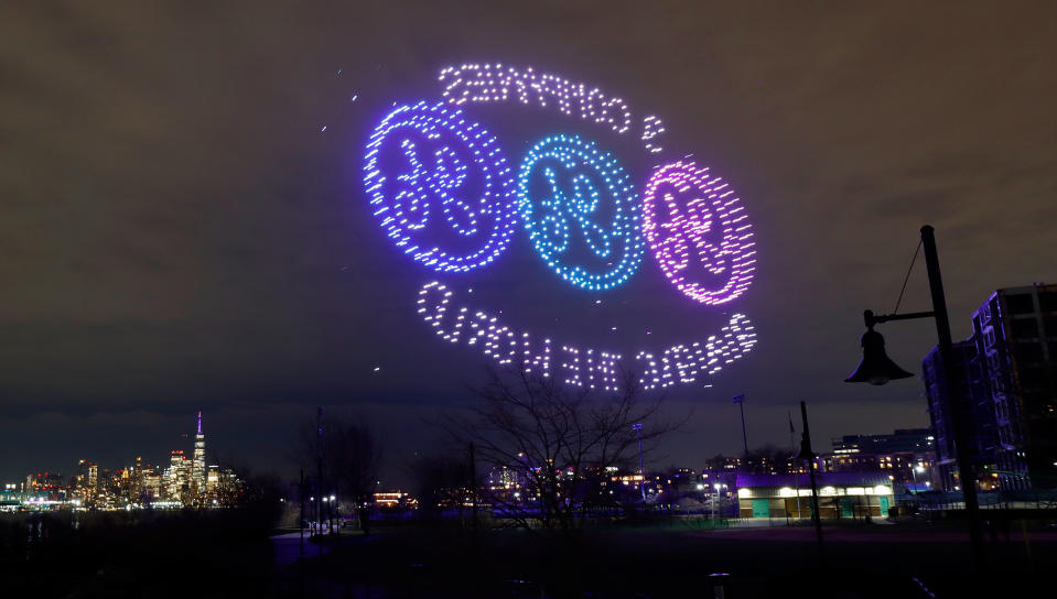 WEHAWKEN, NJ - APRIL 1: A drone display sponsored by General Electric lights up in front of Lower Manhattan and the World Trade Center in New York City on April 1, 2024, in Weehawken, New Jersey.  The offering was before GE splits into three companies: GE Aerospace, GE Vernova and GE Healthcare, which will begin trading on the New York Stock Exchange on April 2.  (Photo by Gary Hirschorn/Getty Images)