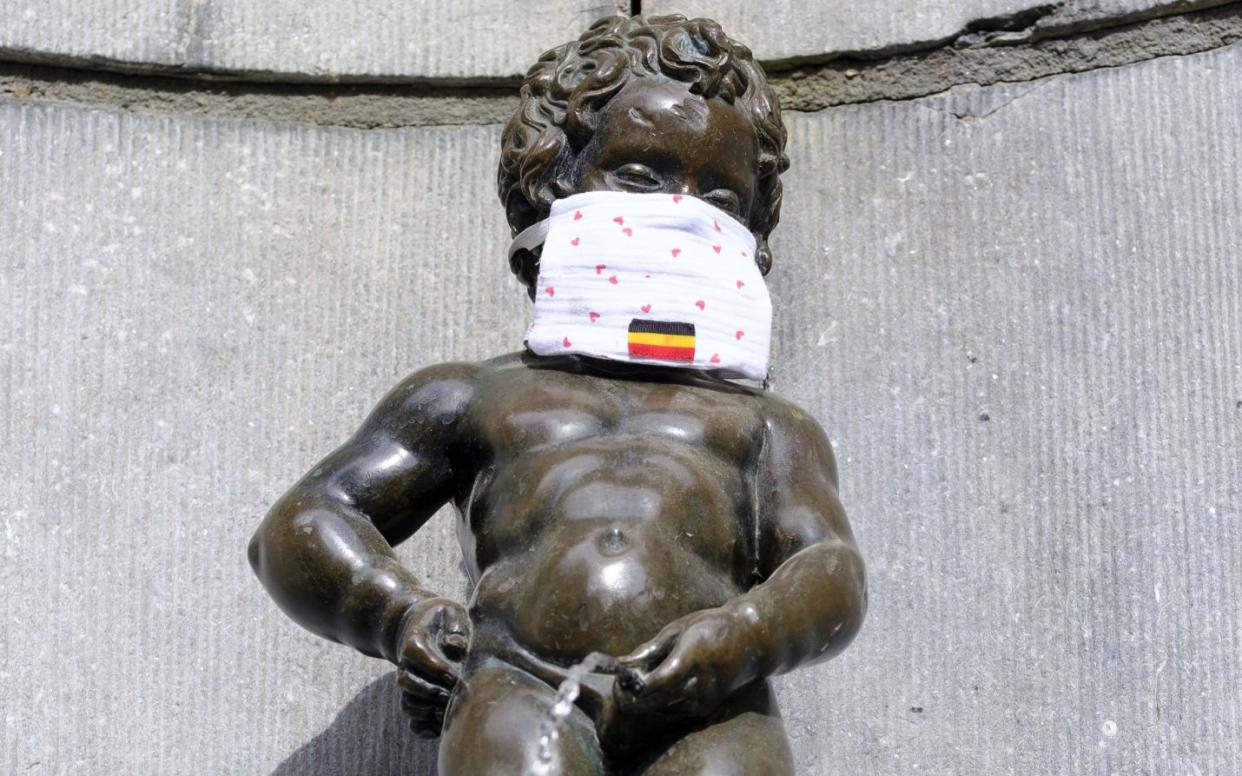 Brussels's iconic Manneken Pis statue, complete with face mask.  - Thierry Monasse /Getty Images Europe 