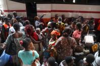 Residents wait at the bus station as they prepare to leave the capital for the remote villages ahead of a contentious election many fear could turn violent, in Abidjan