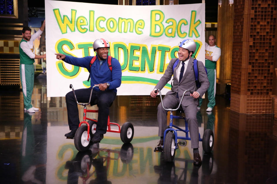 Football player Michael Strahan and host Jimmy Fallon during the Giant Tricycle Race on September 7, 2016.