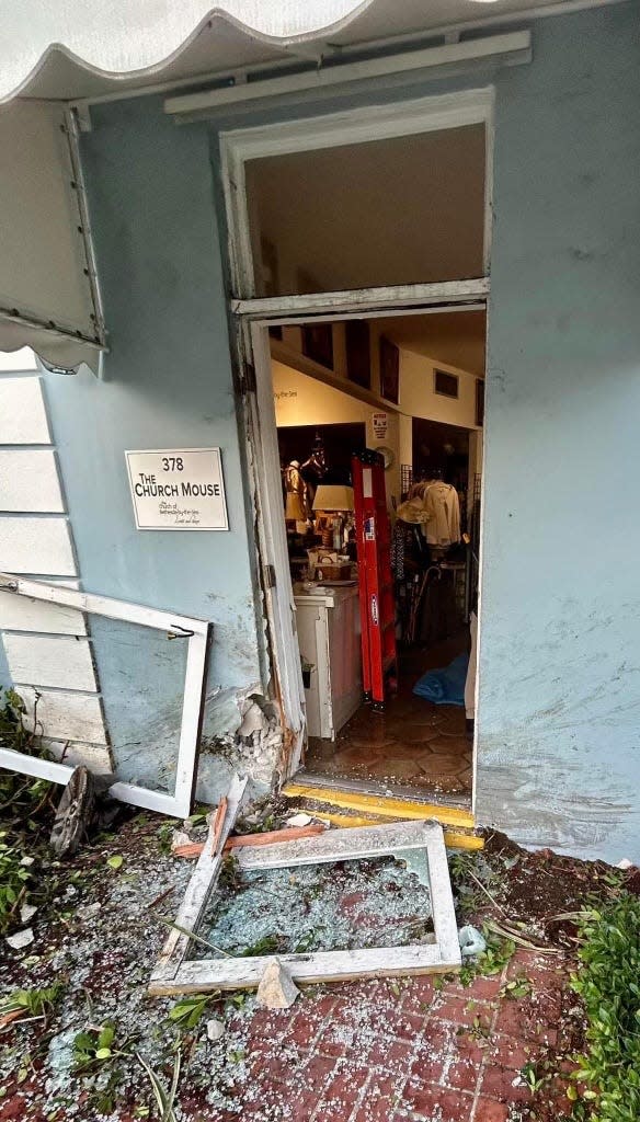 The front entrance of The Church Mouse was damaged early Wednesday after police say a driver lost control of her SUV and crashed into the building.
