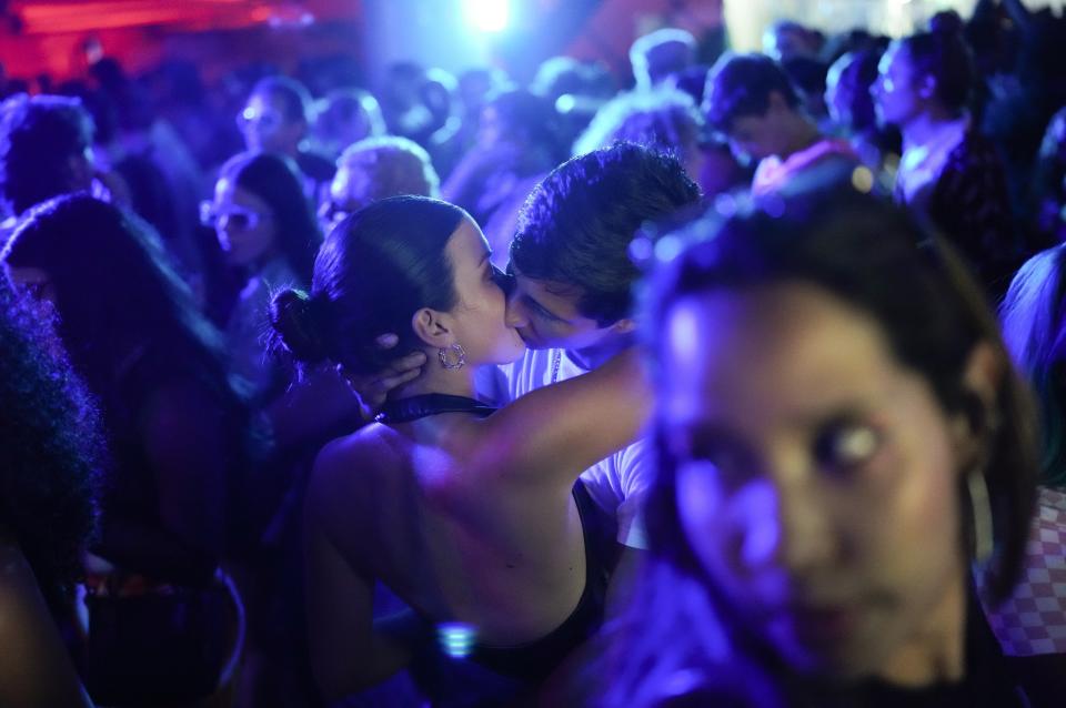 A couple kisses as they dance at a DJ party in Caracas, Venezuela, early Saturday, Sept.10, 2022. (AP Photo/Ariana Cubillos)