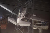 First responders work to rescue aircraft passengers after the small plane crashed and became stuck in live power lines, Monday, Nov. 28, 2022, in Montgomery Village, a northern suburb of Gaithersburg, Md. Both occupants were successfully rescued. (AP Photo/Tom Brenner)