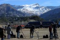 Police vans block the view as Japanese victims pay their respects on March 29, 2015 near a commemorative headstone in Seyne-les-Alpes, the closest accessible area to where a Germanwings flight crashed in the French Alps