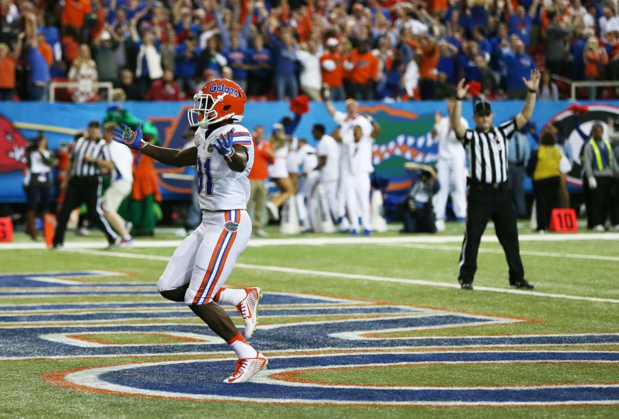 Florida receiver Antonio Callaway (81) runs back a punt for a touchdown during the first half of the SEC championship game. (AP Photo/John Bazemore)