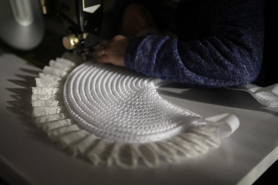 Beatrice Kersten works at her sewing machine inside the family costume workshop in Binche, Belgium, Wednesday, Feb. 1, 2023. After a COVID-imposed hiatus, artisans are putting finishing touches on elaborate costumes and floats for the renowned Carnival in the Belgian town of Binche, a tradition that brings together young and old and is a welcome moment of celebration after a rough few years. (AP Photo/Virginia Mayo)