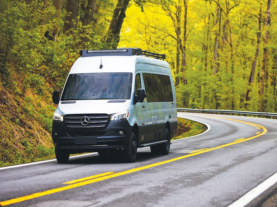 The Airstream 2022 Interstate 24X Touring Coach driving down a road