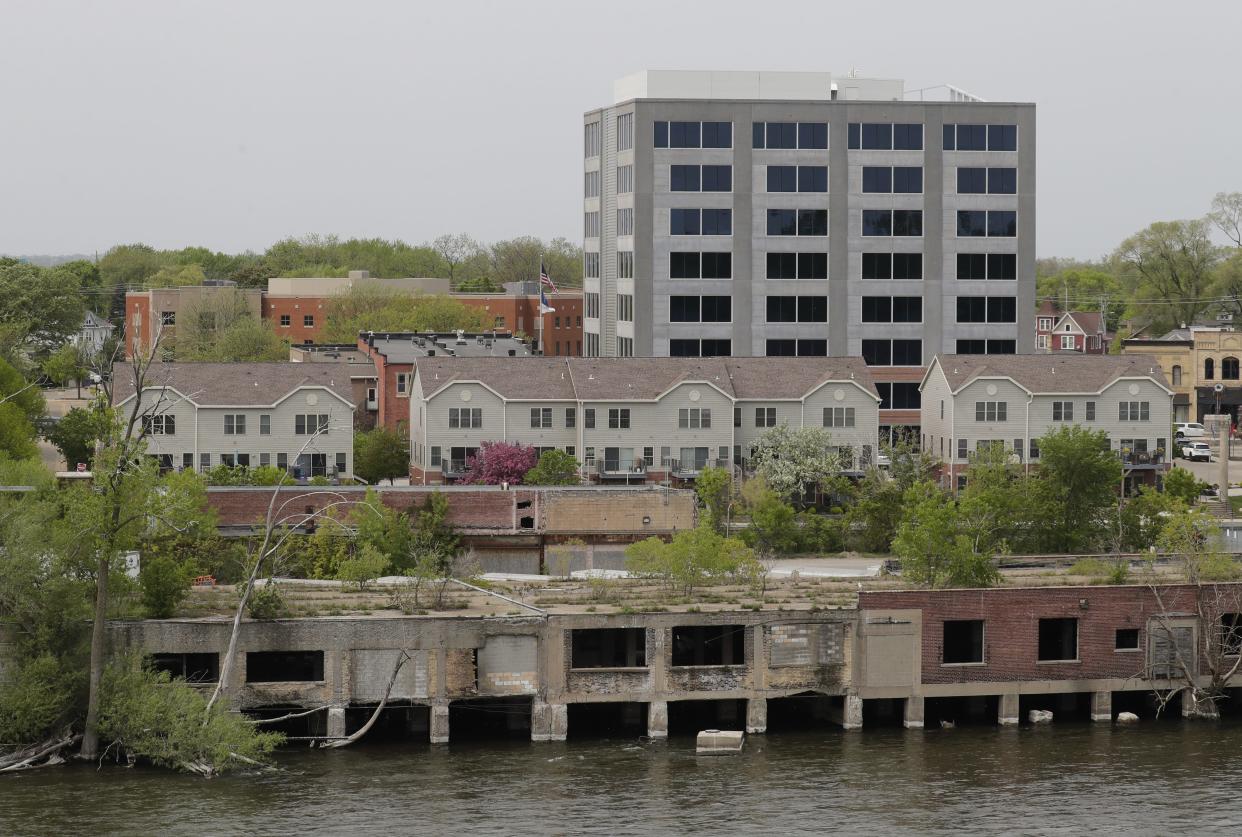 The dilapidated building along the Fox River in Menasha will get some attention this year from Sonoco. In the background are the Marina Place condominiums and One Menasha Center.