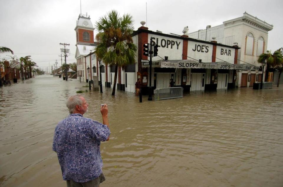 .Bob Graham, a local business owner, photographs Sloppy Joes Bar on Duval street in Key West flooded by the surge of hurricane Wilma on Oct. 24, 2005.