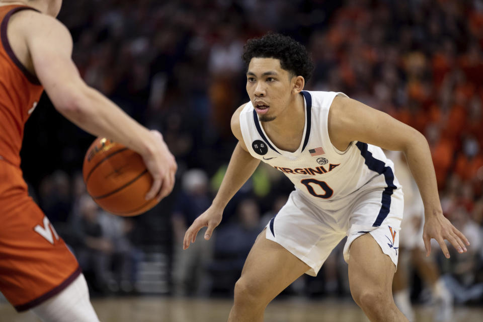 FILE -Virginia's Kihei Clark (0) falls back on defense against Virginia Tech during the second half of an NCAA college basketball game in Charlottesville, Va., Wednesday, Jan. 18, 2023. Kihei Clark may never top his biggest highlight in Virginia basketball lore, but the 5-foot-10 point guard's presence in the No. 10 Cavaliers' lineup could certainly give him another chance.(AP Photo/Mike Kropf, File)