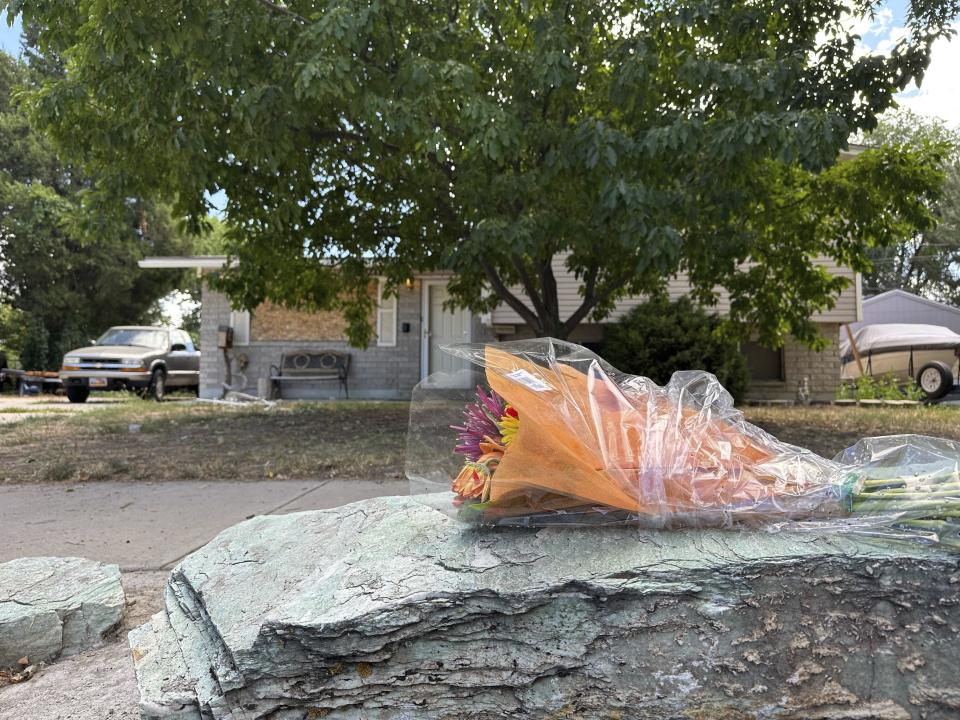 Flowers laid by firefighters are seen in front of the home of Craig Robertson, Thursday, Aug 10, 2023, in Provo, Utah. Robertson was killed by FBI agents Wednesday during a confrontation after making violent threats against President Joseph Biden and other public officials. (AP Photo/Sam Metz)