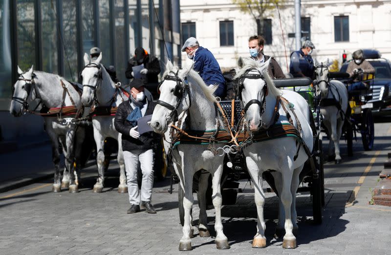 Fiaker horse carriages wait for food packages in Vienna