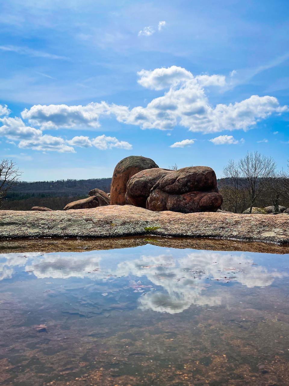 Reflections of clouds in a puddle at Elephant Rocks State Park.