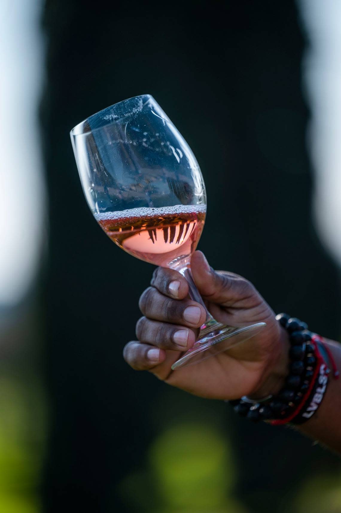 A glass of 23 Wines rosé reflects the landscape at E2 Family Winery in Lodi on Thursday, Jan. 20, 2022. The label is the product of retired Major League Baseball All-Star Greg Vaughn, who grew up in Sacramento and played at Kennedy High School.