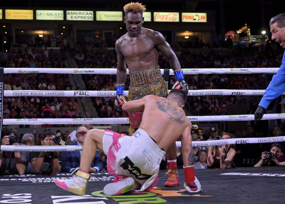 Jermell Charlo (pictured standing up) knocks down Brian Castano (pictured down) during their super middleweight title fight