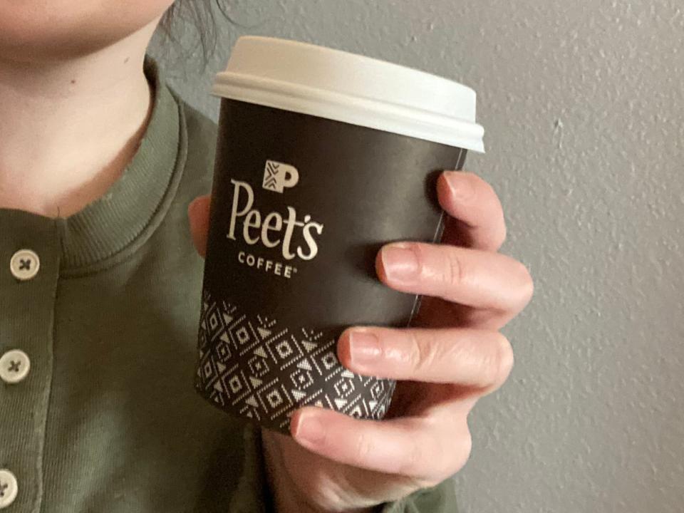 paige bennett holding cup of peet's chai latte