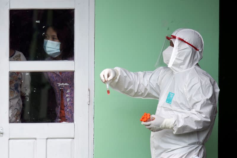 Medical staff wearing a protective suit works at a quarantine center in Yangon