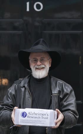 British author Terry Pratchett poses for a photograph before delivering a petition on behalf of the Alzheimer's Research Trust to 10 Downing Street in London, in this November 26, 2008 file photograph. REUTERS/Suzanne Plunkett/files