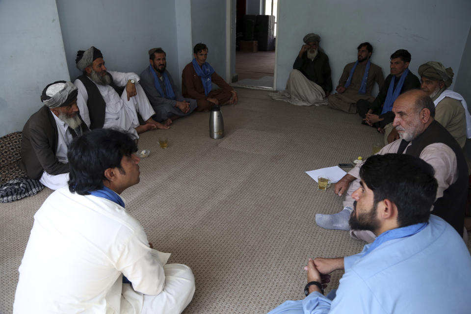 In this Thursday, Aug. 29, 2019, photo, Members of the peace movement chat with each others after an interview with the Associated Press in Kabul, Afghanistan, For almost a year, Afghanistan's more than 30 million people have been in the awkward position of waiting as a United States envoy and the Taliban negotiate their country's fate behind closed doors. (AP Photo/Rahmat Gul)