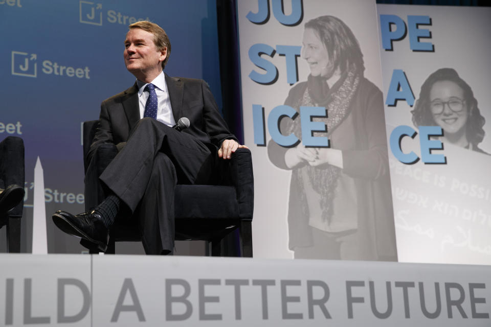 Democratic presidential candidate Sen. Michael Bennet, D-Colo., speaks at the J Street National Conference, with the hosts of "Pod Save the World," Tommy Vietor, left, and Ben Rhodes, Monday, Oct. 28, 2019, in Washington. (AP Photo/Jacquelyn Martin)