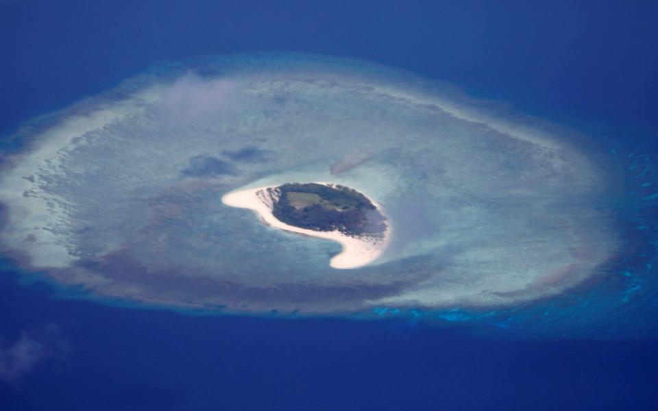 The uninhabited island of Spratly in the South China Sea is one of the many disputed territories in the region - Erik de Castro/Reuters