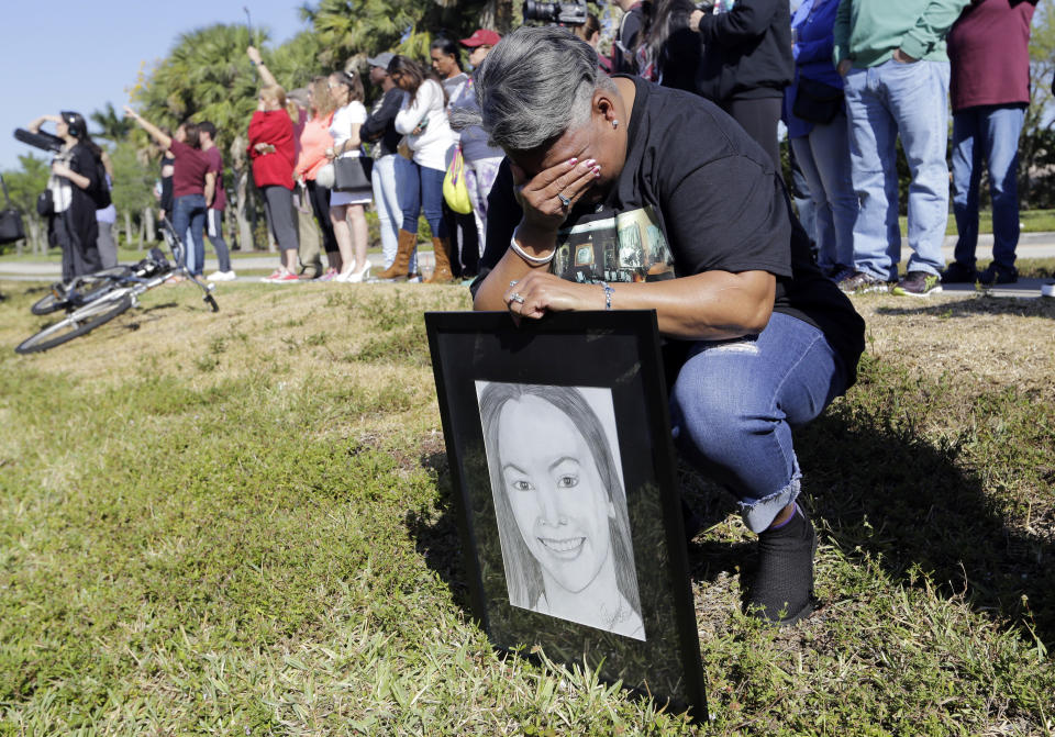 <p>Pat Gibson holds a drawing of Meadow Pollack, a victim of the Marjory Stoneman Douglas High School shooting, as she stands outside of the school as part of a nationwide protest against gun violence, Wednesday, March 14, 2018, in Parkland, Fla. Organizers say nearly 3,000 walkouts are set in the biggest demonstration yet of the student activism that has emerged following the massacre of 17 people at Marjory Stoneman Douglas High School in February. (Photo: Lynne Sladky/AP) </p>