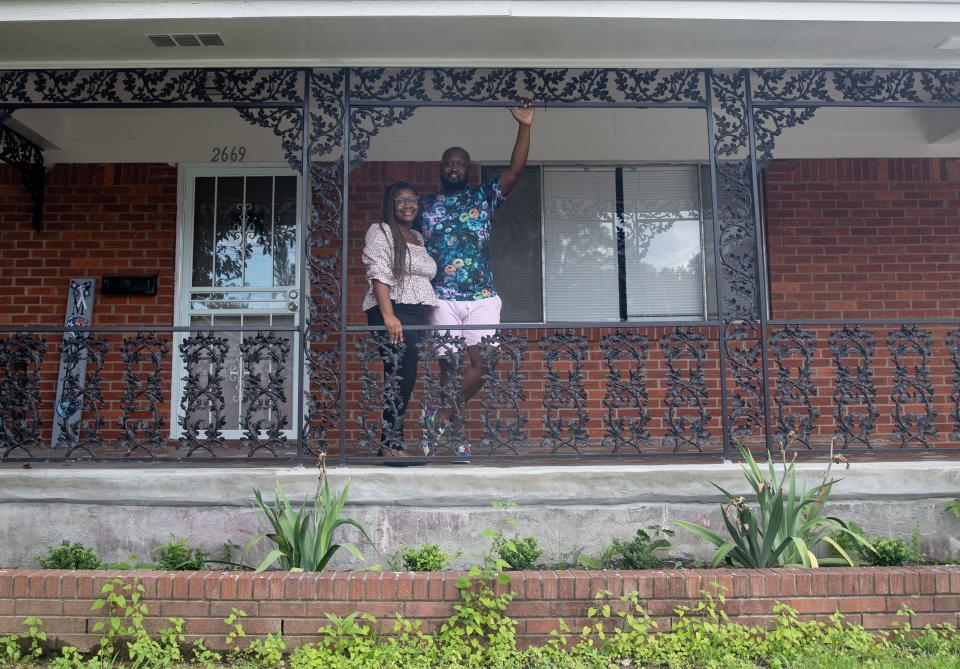 Courtney Taylor-Hurt, left, and her husband C.J. Hurt, right, stand outside their home Wednesday, Aug. 24, 2022, in Memphis. The couple recently bought a house in Orange Mound because of a rent hike at their apartment in Binghampton.