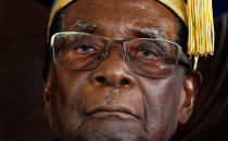 <p>Mugabe sits for formal photographs with university officials after presiding over a graduation ceremony at Zimbabwe Open University, Nov. 17, 2017. Mugabe made his first public appearance since the military put him under house arrest earlier that week. (Photo: Ben Curtis/AP) </p>