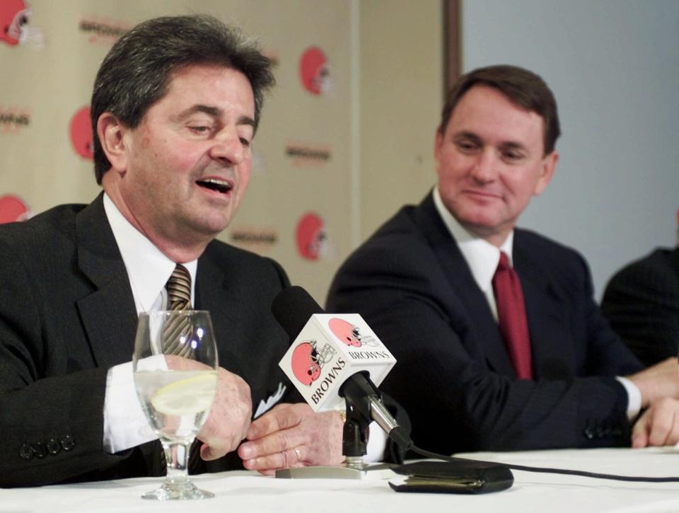 Cleveland Browns President Carmen Policy, left, tosses his wallet on the table when asked about new head coach Butch Davis' contract Tuesday, Jan. 30, 2001, in Berea. (AP Photo/Mark Duncan)