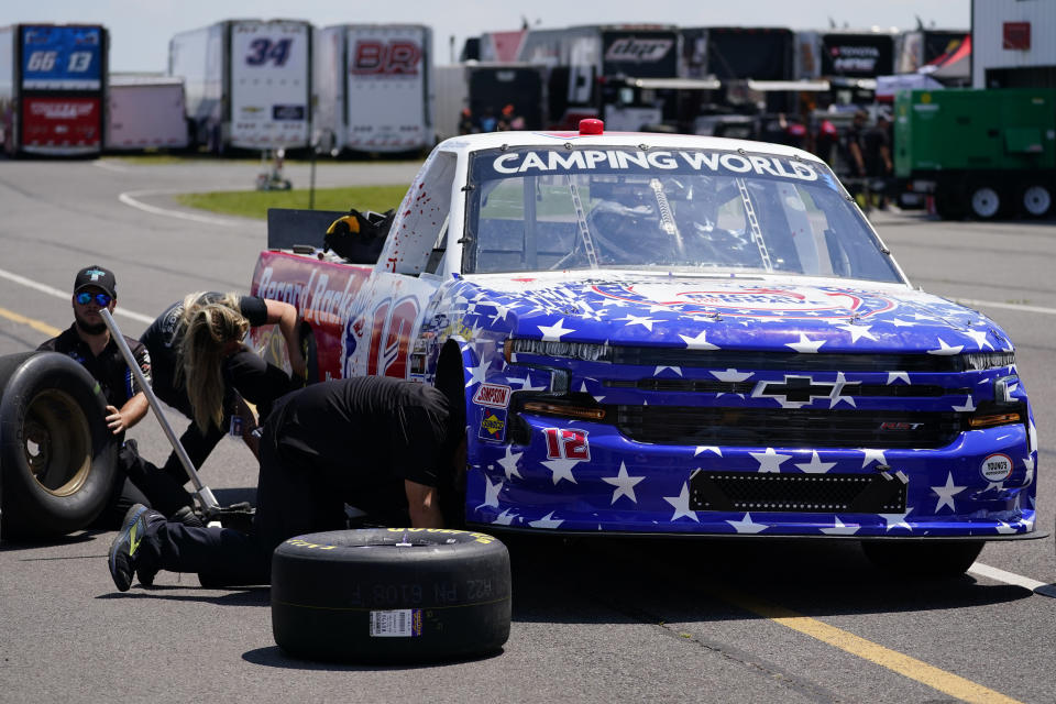 Crew members work on the truck of Spencer Boyd before practice for Saturday's NASCAR Truck Series auto race at Pocono Raceway, Friday, July 22, 2022, in Long Pond, Pa. (AP Photo/Matt Slocum)