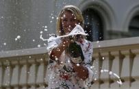 Germany's Angelique Kerber sprays champagne a day after winning her final match at the Australian Open tennis tournament, at the Government House in Melbourne, Australia, January 31, 2016. REUTERS/Issei Kato