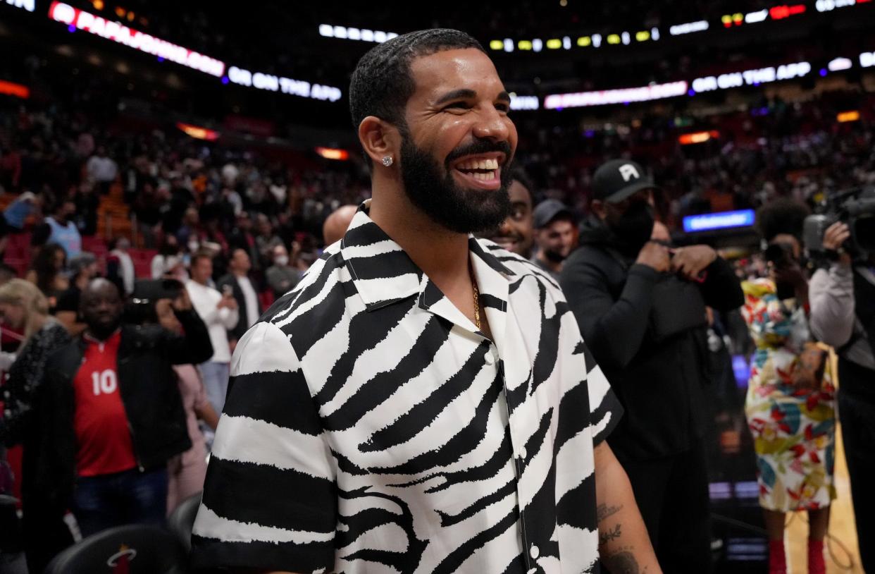 Drake reacts after attending the game between the Miami Heat and the Atlanta Hawks at FTX Arena on January 14, 2022 in Miami, Florida. NOTE TO USER: User expressly acknowledges and agrees that, by downloading and or using this photograph, User is consenting to the terms and conditions of the Getty Images License Agreement.